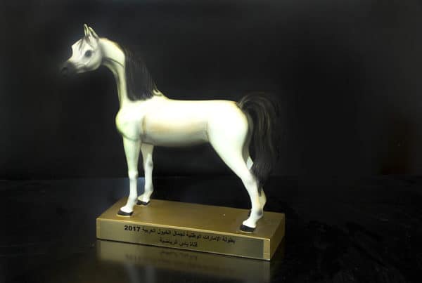 White miniature horse model on wooden base