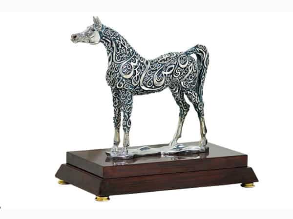 Horse sculpture with Arabic calligraphy on wooden base