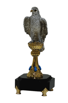 Silver falcon sculpture with branded gems on customized stand