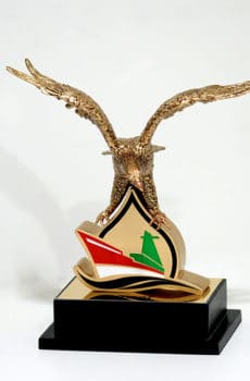 Open wings falcon sculpture on metal plaque