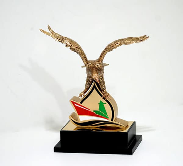 Open wings falcon sculpture on metal plaque