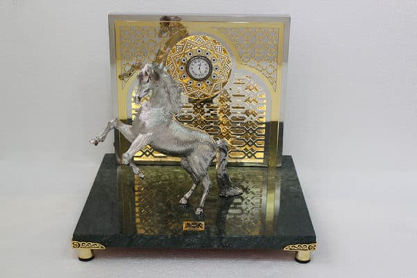 Silver horse on two feet with metal plaque and clock