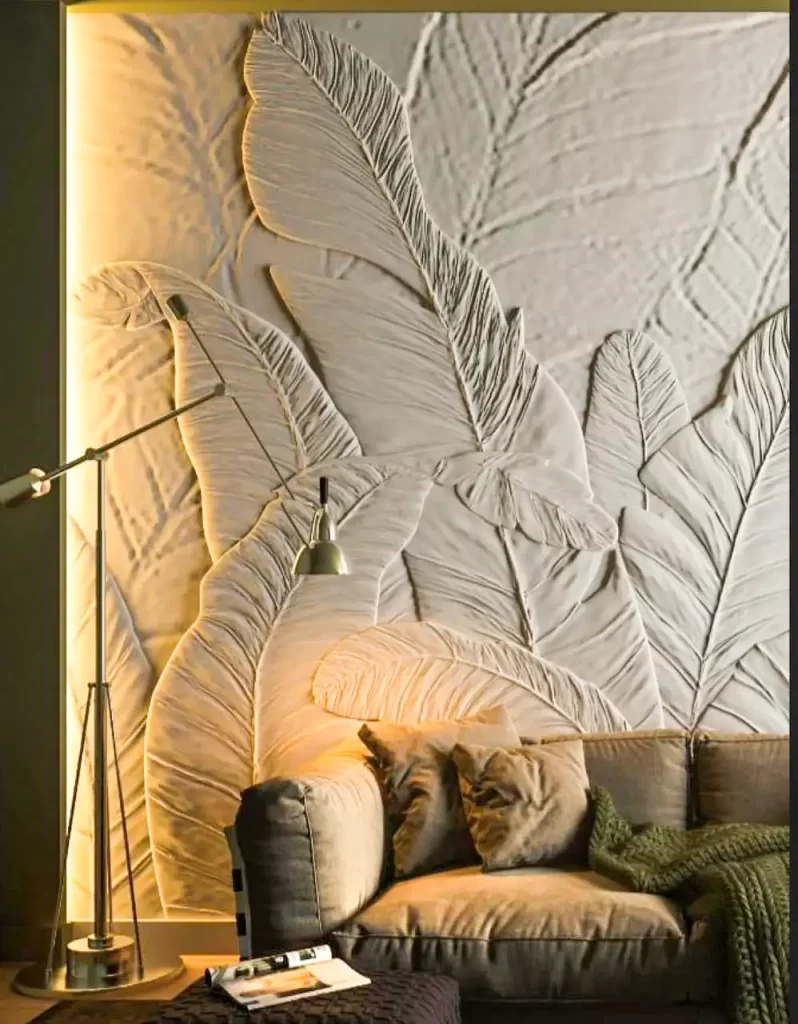 Large-scale leaf-inspired 3D wall relief used as a sophisticated living room backdrop, bringing nature indoors.